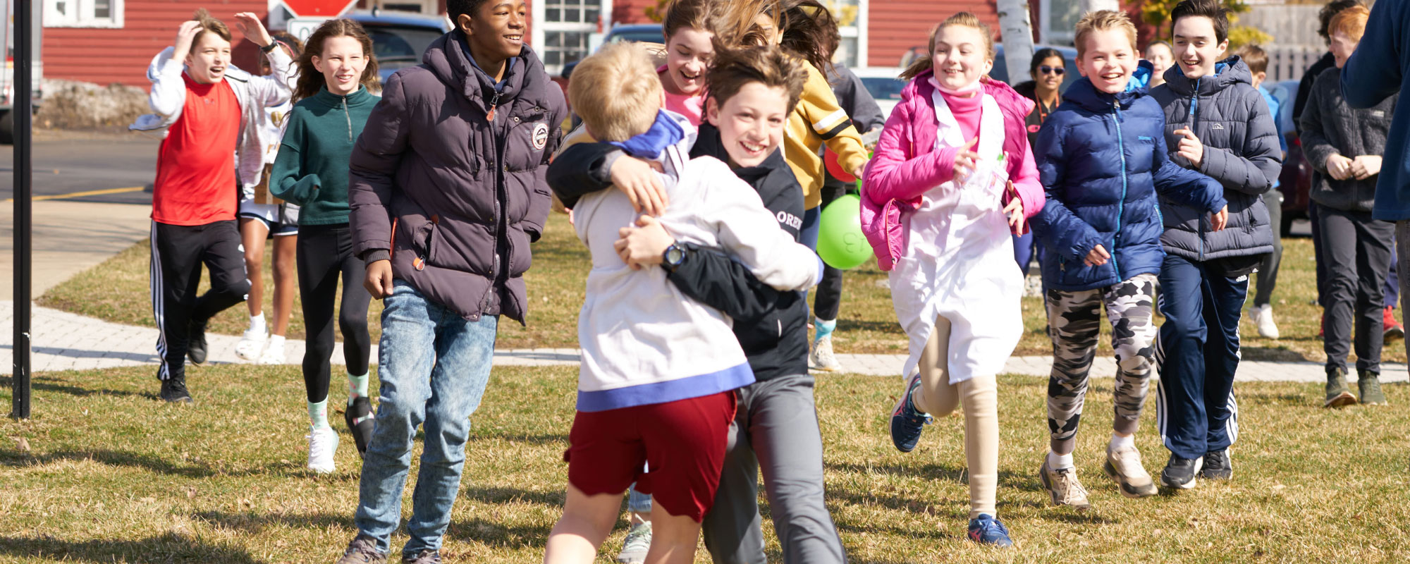 young students playing outside